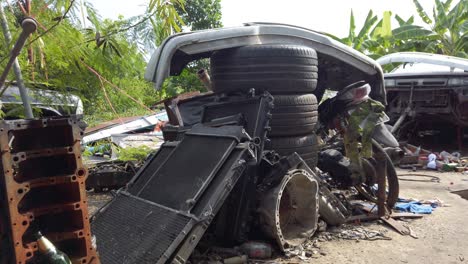 Pile-Of-Tires-And-Broken-Radiators-Of-Wreck-Automobiles-At-Junk-Yard