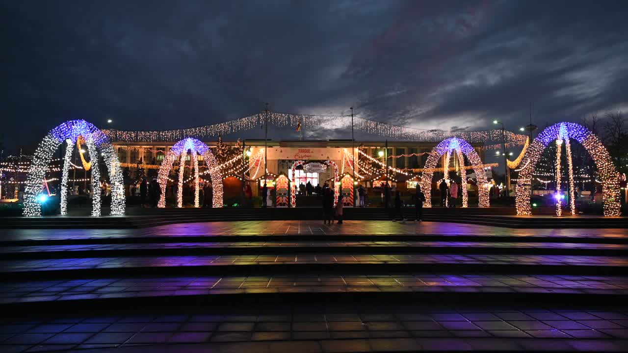Chisinau, Moldova - December 12, 2021: People walking through the Christmas Market in the evening