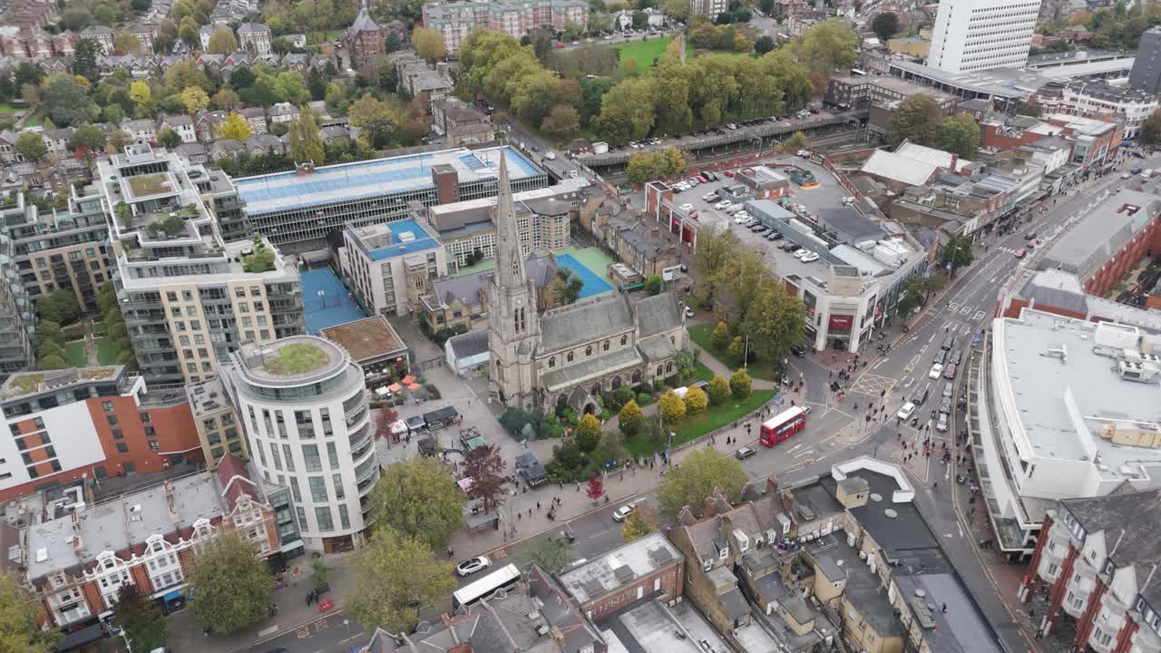 Aerial sweep of Central Ealing showing The Broadway Church, shopping precinct and apartment blocks in London, UK, October 2024