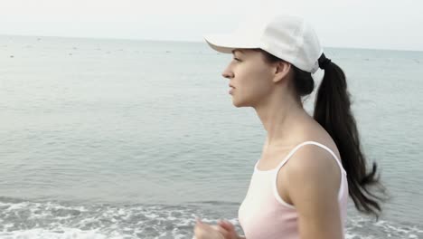 The girl is running by the sea at dawn