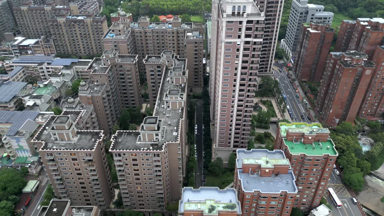 Modern aerial view of high-rise buildings, street, and green spaces in Luzhu District