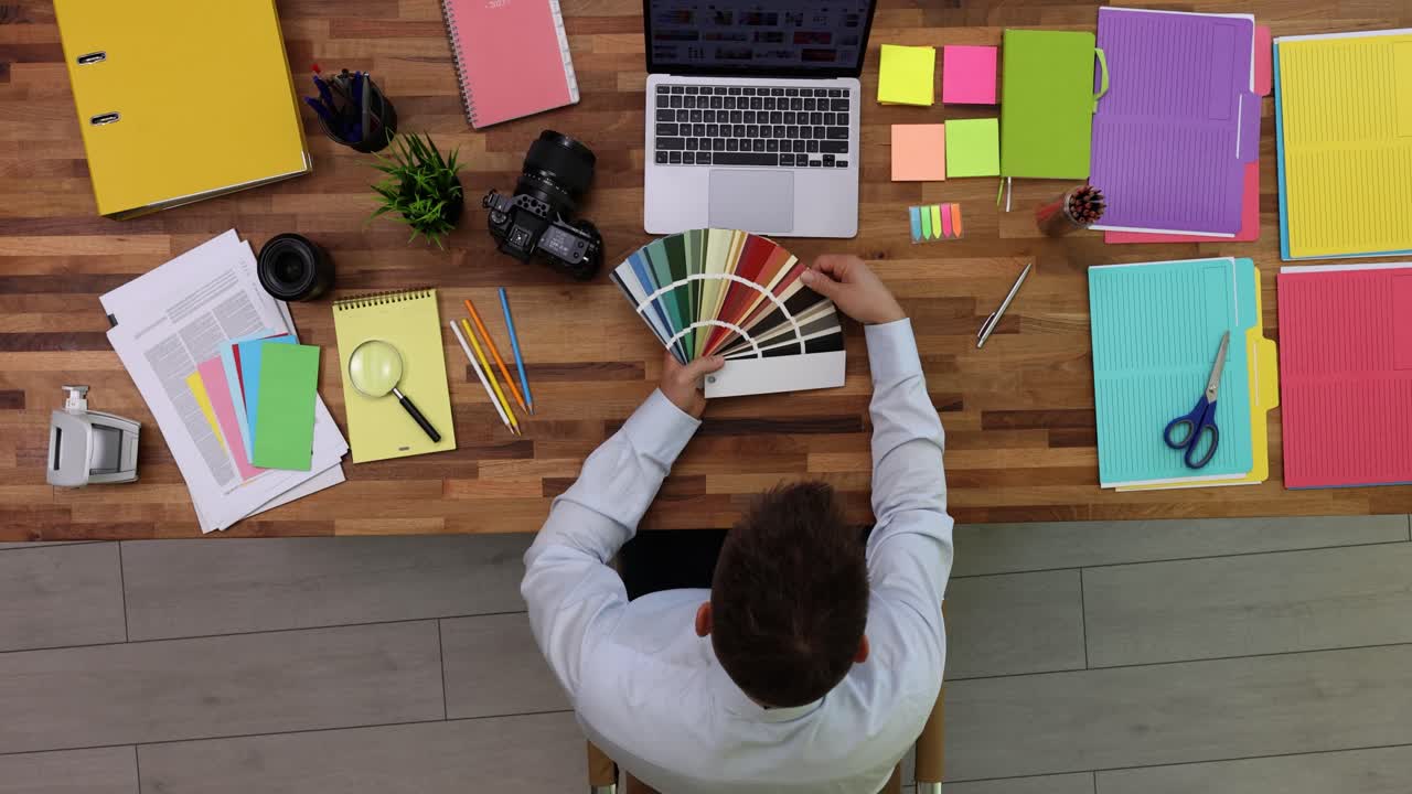 Workspace with color swatches and laptop