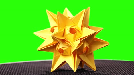 spiked origami figure of yellow color.