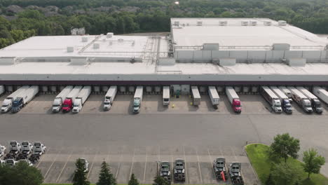 Aerial-Panorama-of-Multiple-Semi-Trucks-Parked-at-Warehouse-Loading-Dock