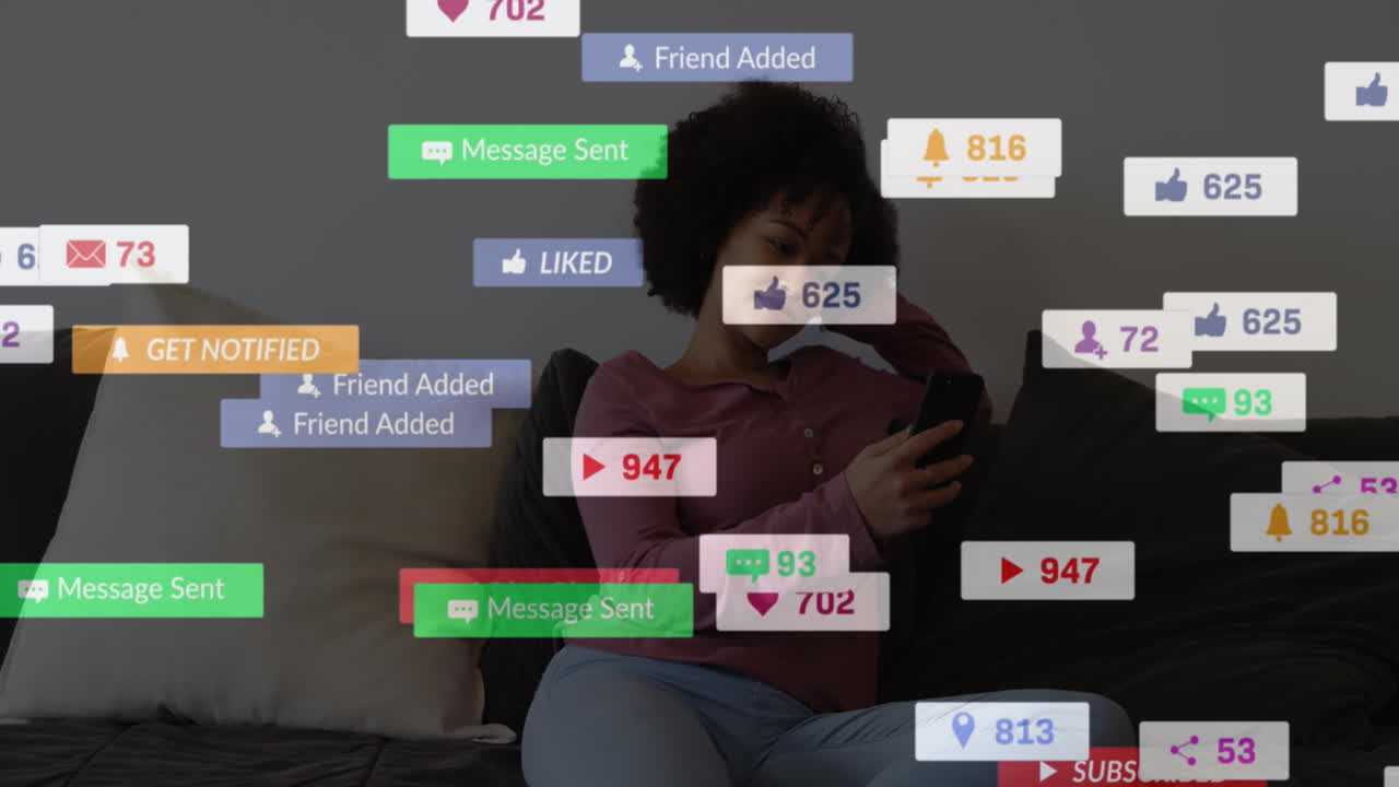 animación de números, iconos y textos en la barra de mensajes, mujer biracial sonriente usando teléfono celular en casa