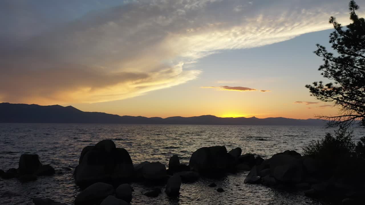 Silhouette Of Tree And Rocks At Dusk In Lake Tahoe, California, USA - aerial