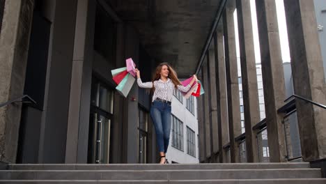 stylish girl with shopping bags, rejoicing discounts in store, dancing, celebrating. black friday