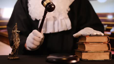 a gavel strikes down in a courtroom setting, symbolizing justice and legal authority with law books