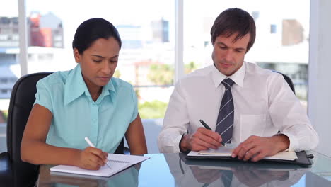 welldressed people writing on organizer