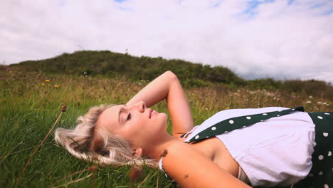 attractive happy blonde lying down on lawn