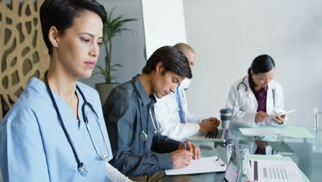 young doctors sitting at a table working together 4k