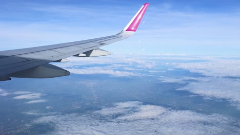 airplane wing view from above the clouds