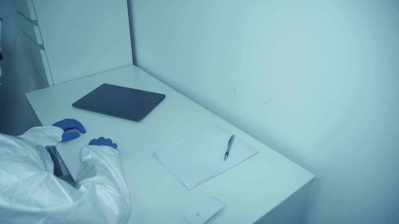 Medical Staff In Personal Protective Equipment Finished Working On His Laptop During Covid19 Pandemic