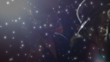 group friends leaning into chat at entertainment event, sparkling star lights floating above faces
