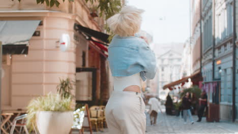 excited surprised woman rejoices jumping with happiness feeling delight victory on city street