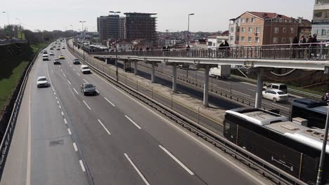 highway scene with pedestrian bridge and traffic in a city