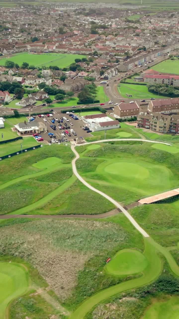 High overhead social ratio aerial video of Royal Portrush Golf Course in County Antrim, Northern Ireland, UK on a sunny day. Produced in 1080x1920 vertical ratio, 60FPS and with Rec709 color