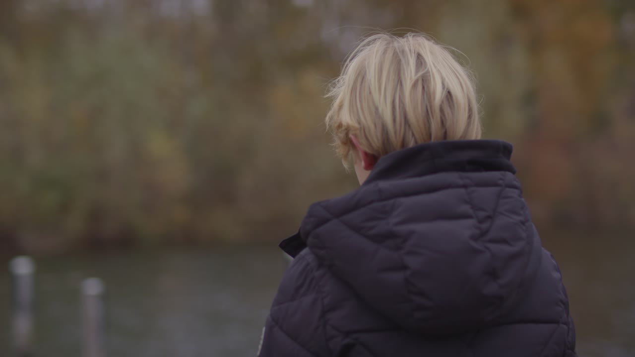 Close up of young boy overlooking river
