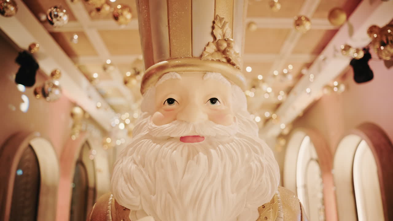 Close up of a Santa Claus figure inside a festive Christmas installation with warm lights and ornaments