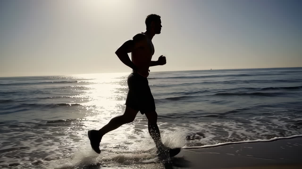 Silhouette of a Man Running on the Beach at Sunrise or Sunset