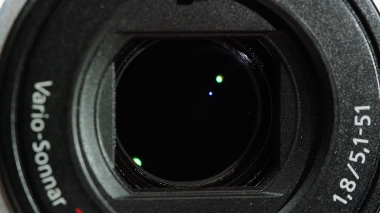 Close-up of Vintage video-camera. Close and open lens zoom of camera. Using portable camcorder to shooting videos