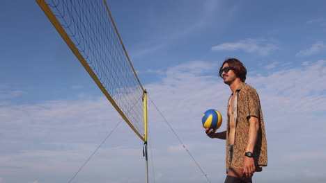 happy beach volleyball player holding ball.