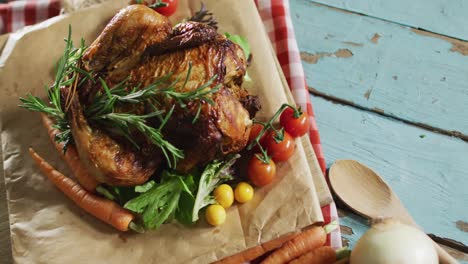 close up view of cooked chicken and multiple food ingredients on wooden surface