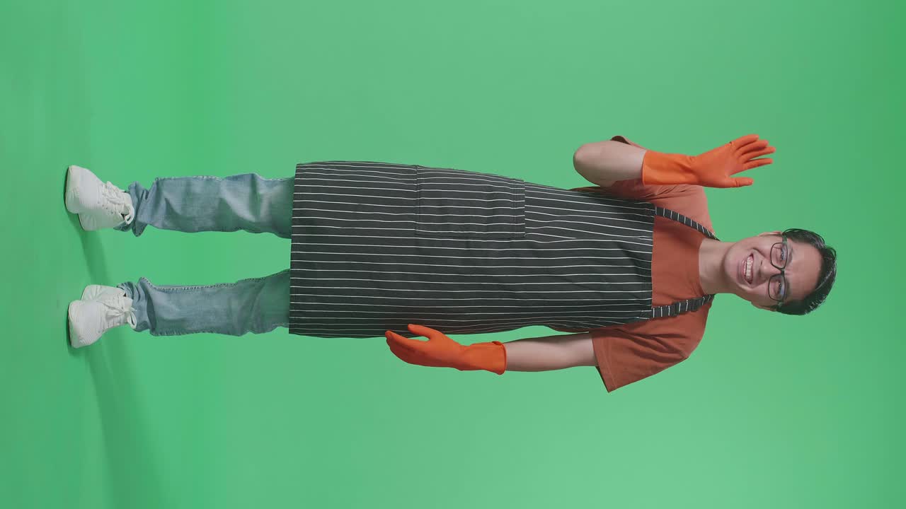 Man Wearing Apron and Gloves
