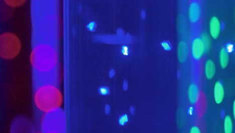 colorful out of focus blurred bokeh lights moving in the dark room, beautiful abstract background, copyspace