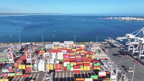 container yard beside blue coastal waters at melbourne shipping terminal viewed from above