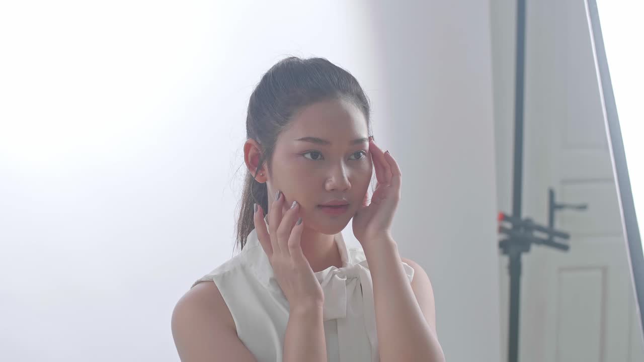 Woman Touching Her Face in a Studio Setting