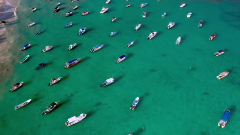 Cinematic-shot-of-boats-anchored-in-the-ocean-at-Playa-Del-Carmen-Mexico