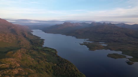 Slow-motion-shot-of-the-beautiful-landscape-of-a-island-in-between-the-mountains-of-Loch-Maree,-Beinn-Eighe,-Kinlochewe-at-Scotland