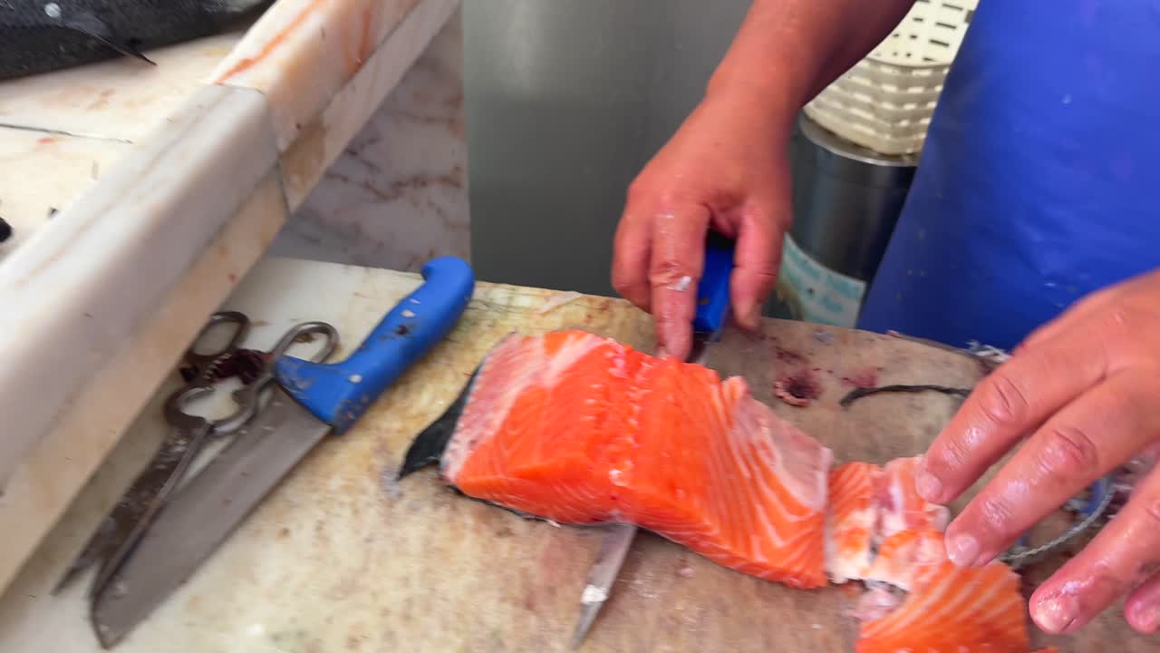 Person filleting fresh salmon
