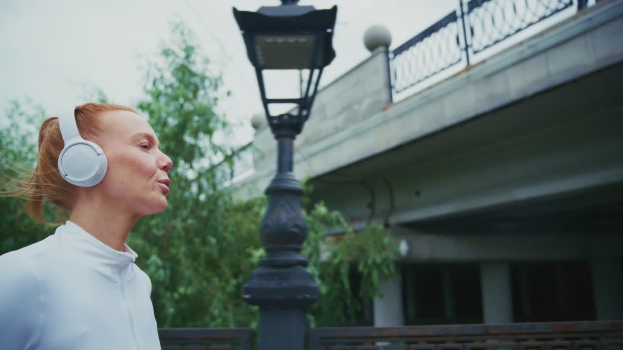 A woman jogging with headphones on