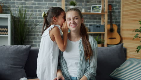 mother and daughter sharing a secret