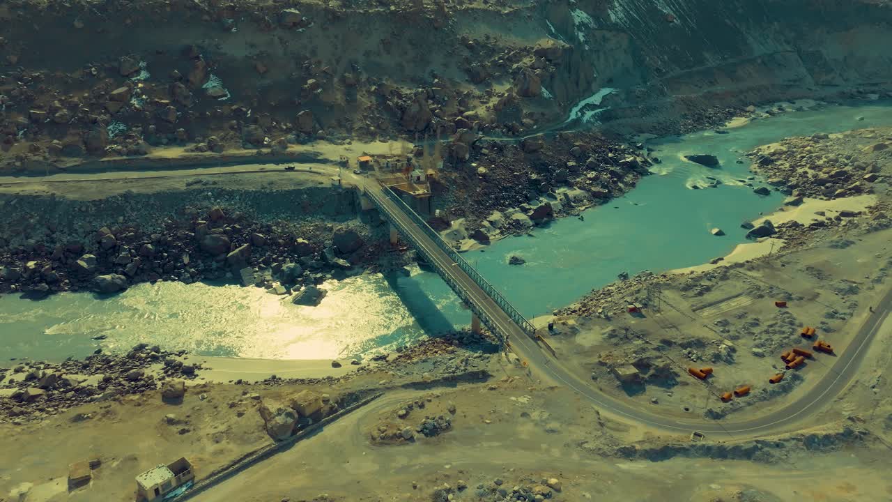 Aerial View of a Bridge over a River in a Mountainous Landscape