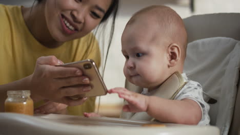 mother and baby looking at a phone