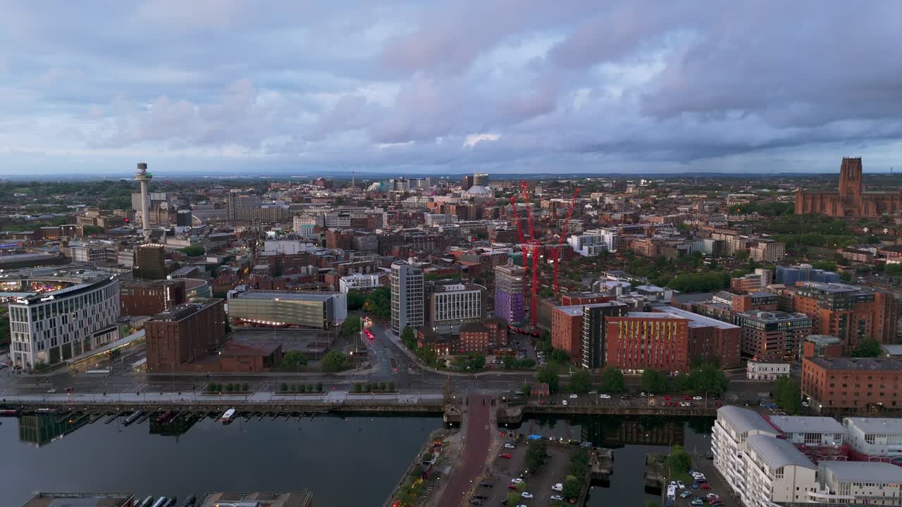Liverpool cityscape at dusk, Radio City Tower, Cathedral, historic docks, England, UK. Aerial forward, copy space