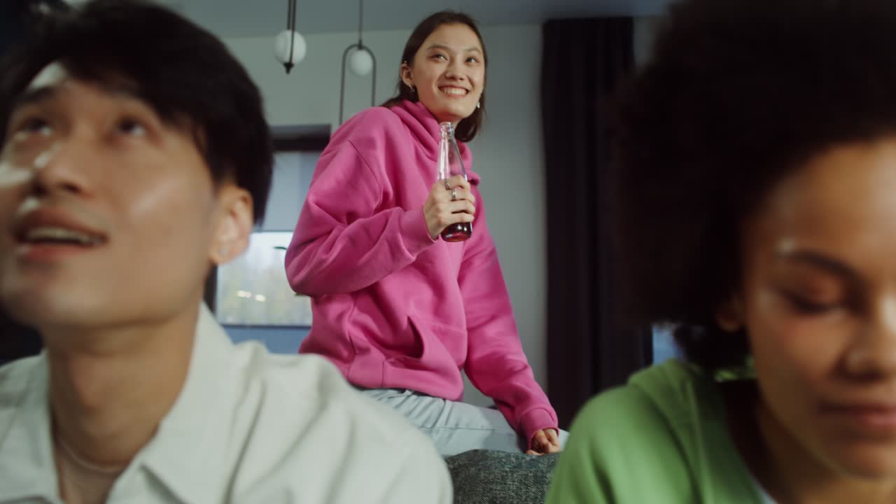 People indoors with a bottle and beverages