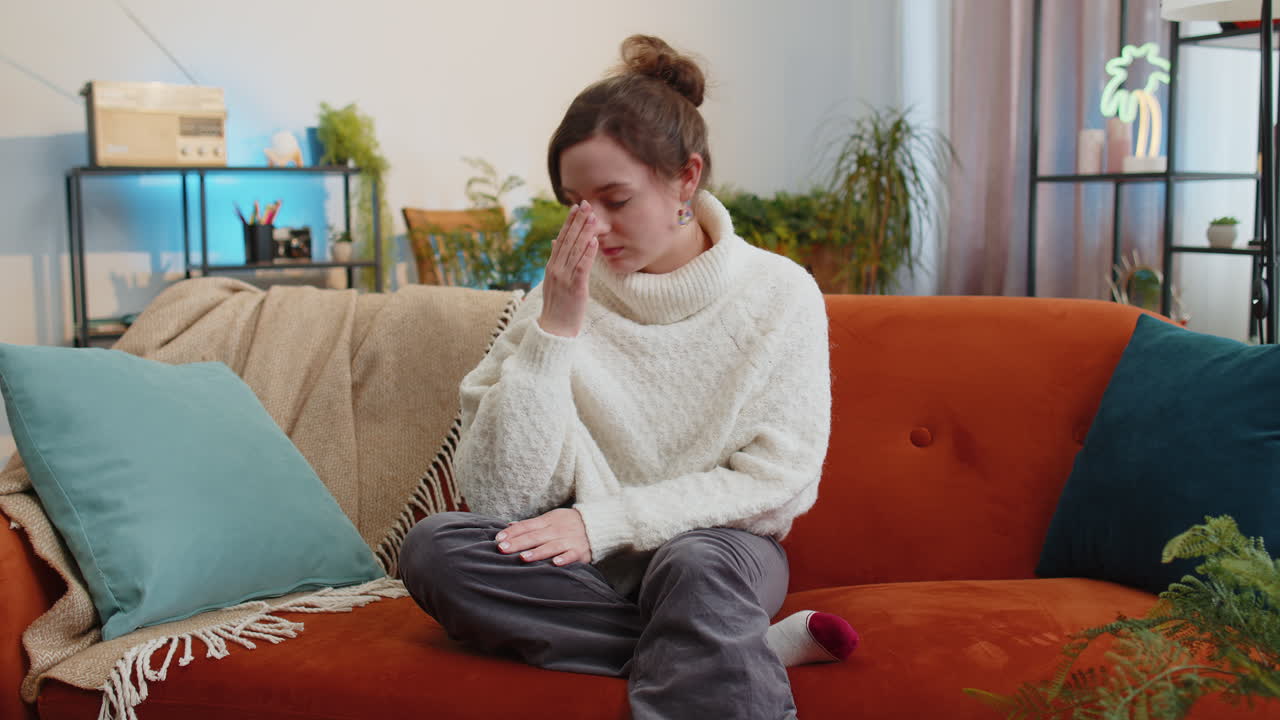 Displeased young woman rubbing temples to cure headache problem suffering from migraine stress