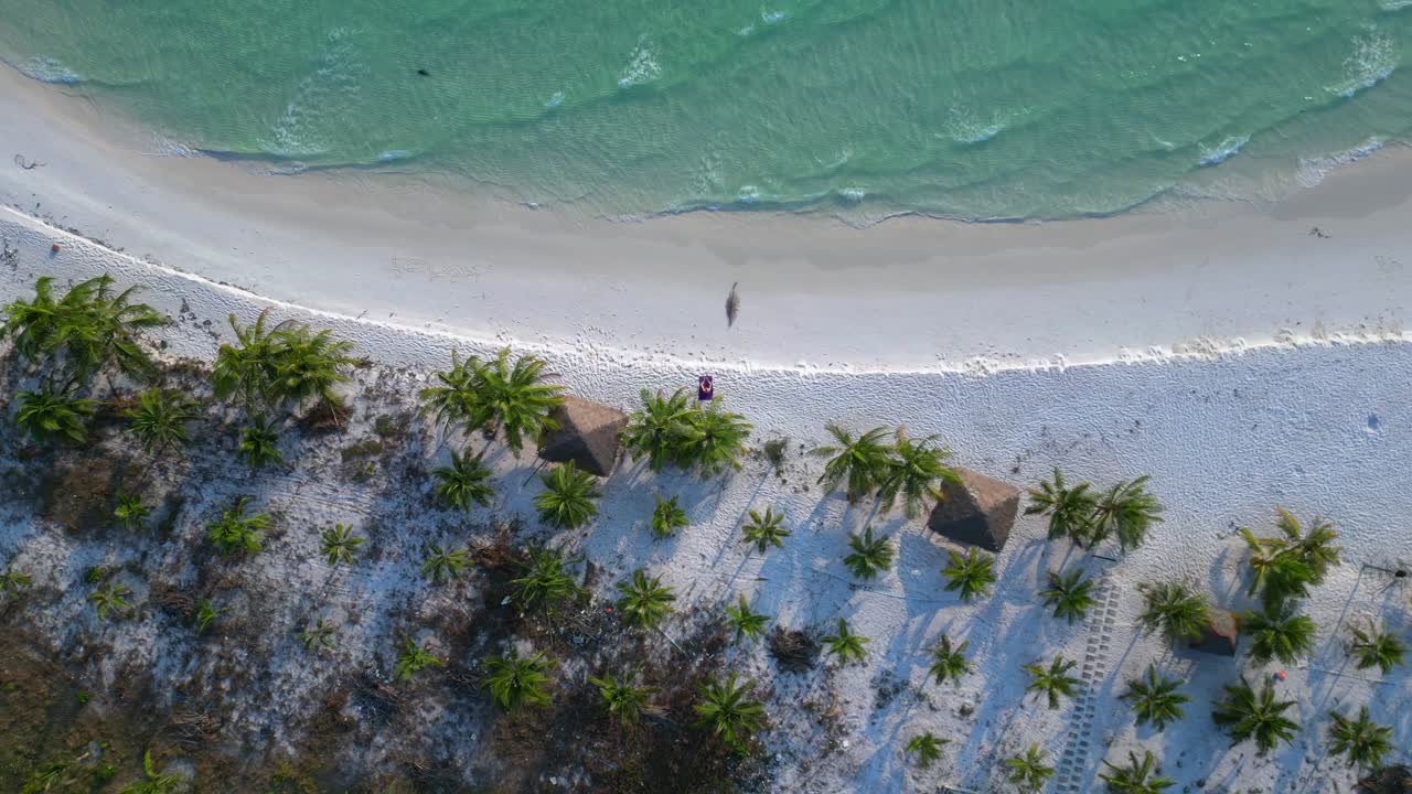 Santa claus is enjoying summer holidays on a beautiful tropical beach. Great aerial view flight drone camera pointing down