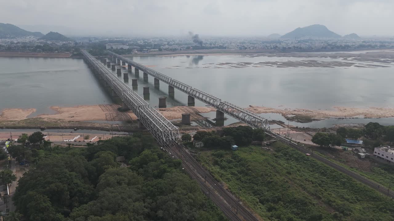 Aerial View of a Long Railway Bridge over a Wide River in India