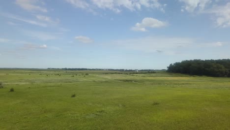 Sweeping-aerial-view-of-pasture-and-marsh-in-rural-South-Dakota