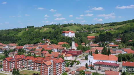 aerial pedestal shot lowering down into the town of lendava, slovenia on a bright summer day