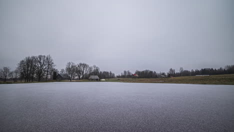 Hyper-lapse-transition-spring-to-winter-of-house-near-lake-near-Riga,-Latvia