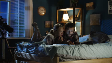 couple relaxing in bed at night