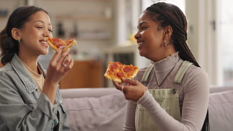 two friends eating pizza together indoors