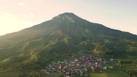 birds eye view over a village on the dieng plateau with mount sindoro in the wonosobo region in central java indonesia