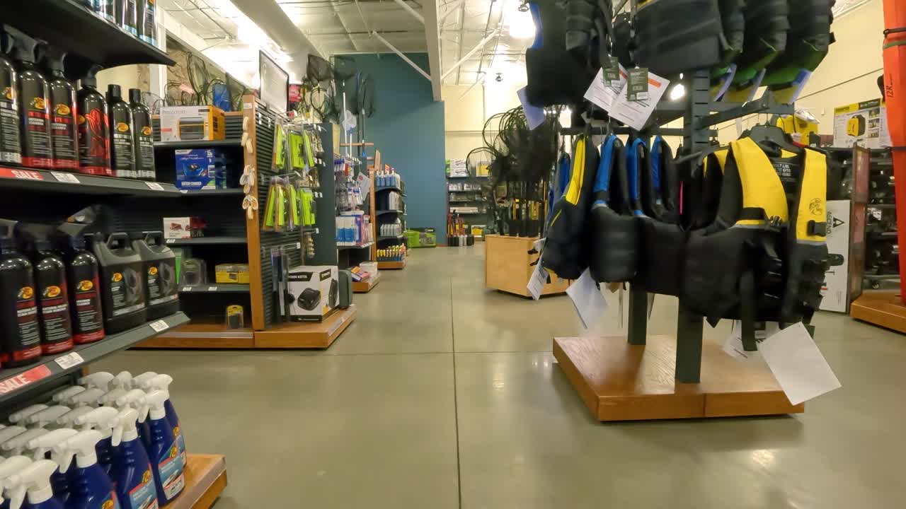 POV - Shopping in Cabela's Marine and Boating department; walking past at life vests, motor oil, fire extinguisher and fishing nets; concepts of outdoor life and adventure,